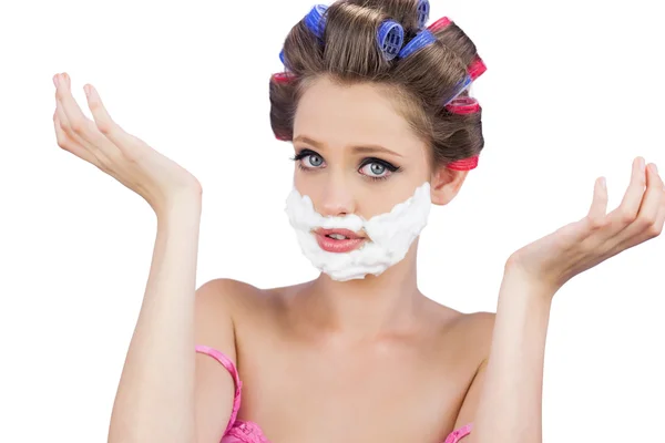 Questioning woman with shaving foam on face — Stock Photo, Image