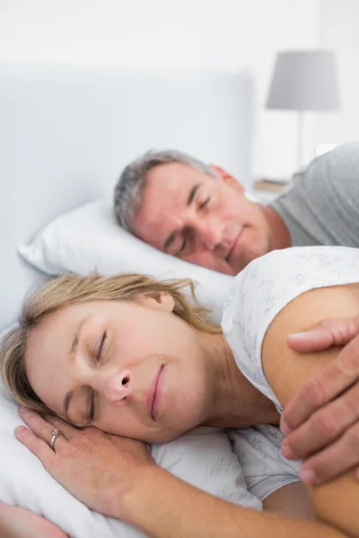 Friedliches Paar schläft und löffelt im Bett — Stockfoto