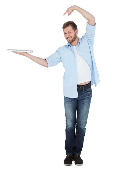 Happy model holding laptop on right hand with flair — Stock Photo, Image