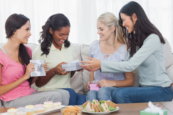 Friends offering gifts to dark woman during party — Stock Photo, Image