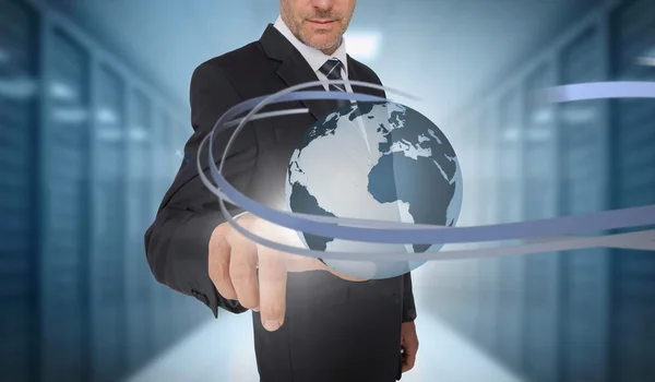 Businessman touching world on futuristic interface with swirling — Stock Photo, Image