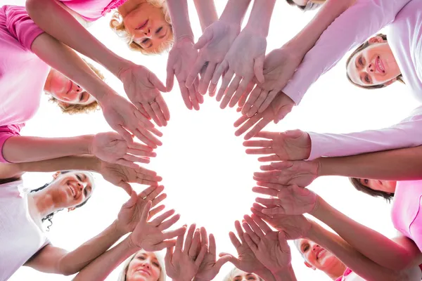 Happy women in circle wearing pink for breast cancer — Stock Photo, Image