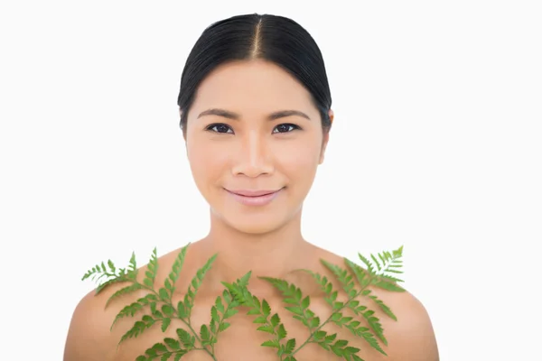 Sensual dark haired model posing with fern — Stock Photo, Image
