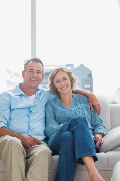 Casal alegre relaxante em seu sofá — Fotografia de Stock