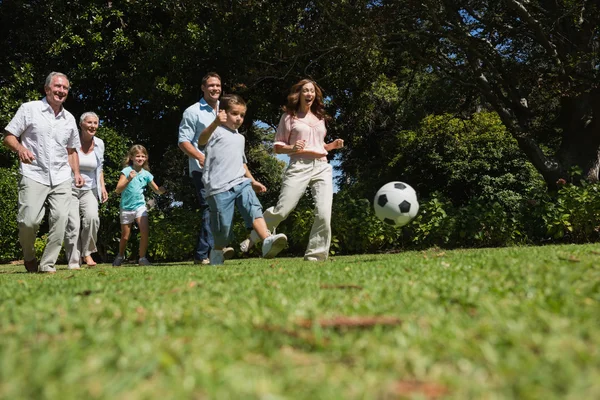 Cheerful multi generation family playing football — Stock Photo, Image