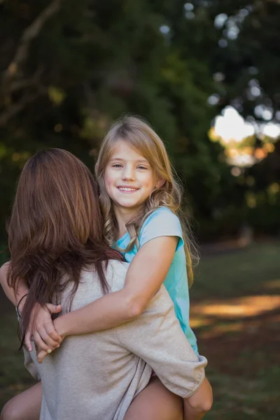 Mother holding her daughter in arms — Stock Photo, Image