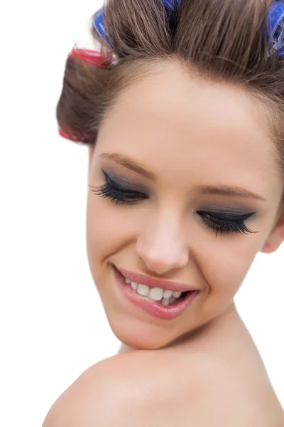 Model wearing hair curlers smiling in close up — Stock Photo, Image