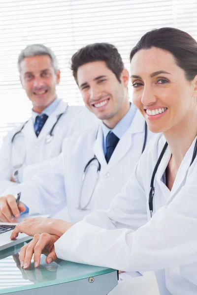 Smiling doctors looking at camera — Stock Photo, Image