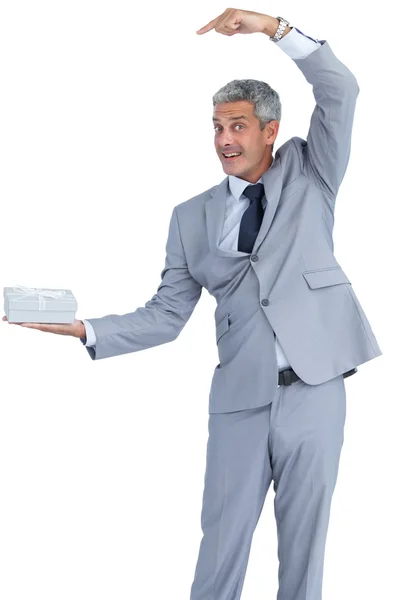 Funny businessman holding gift in right hand — Stock Photo, Image