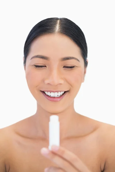 Cheerful pretty natural model using chap stick — Stock Photo, Image