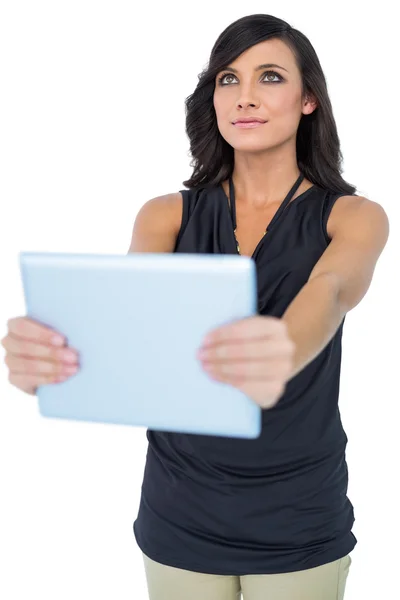 Elegante modelo de pelo oscuro sosteniendo la tableta mirando hacia arriba — Foto de Stock