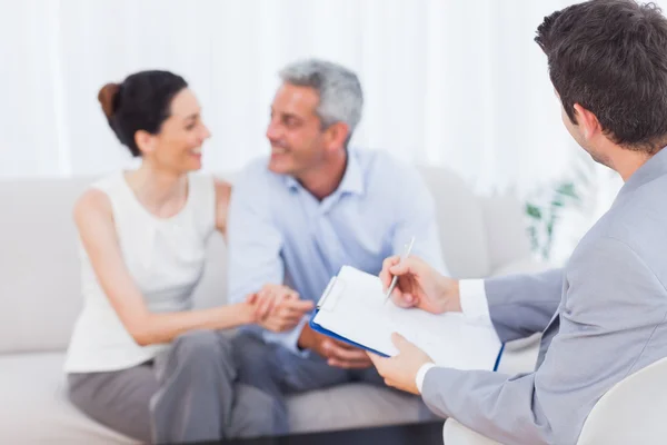 Couple speaking while salesman is holding contract — Stock Photo, Image