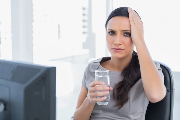 Attractive secretary with headache touching her head — Stock Photo, Image