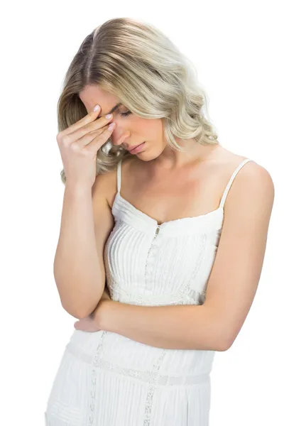 Sensual blonde having headache touching her forehead — Stock Photo, Image