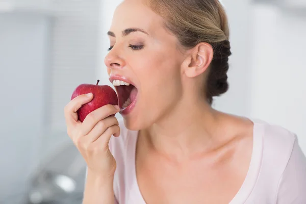 Pretty woman munching apple Stock Picture