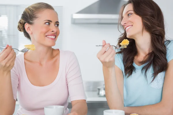 Smiling friends eating cake and having coffee Stock Photo