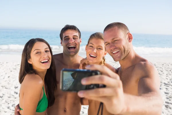 Cheerful friends taking pictures of themselves Royalty Free Stock Photos