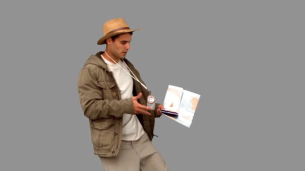 Handsome man orienteering on grey screen — Stock Video