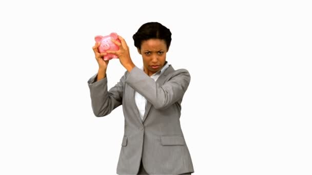 Businesswoman listening to an empty piggy bank on white screen — Stock Video