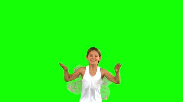 Girl wearing dragonfly wings and jumping on green screen — Stock Video