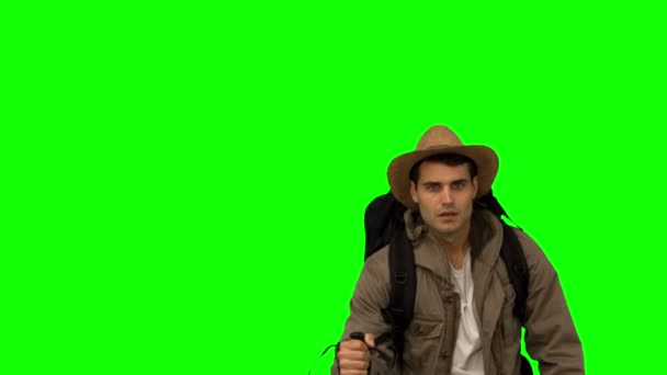 Man with a hat walking under leaves falling on green screen — Stock Video