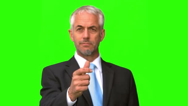 Businessman throwing a coin in the air on green screen — Stock Video