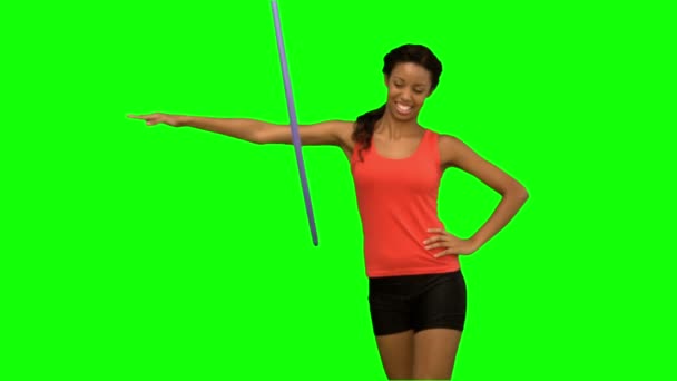 Woman working out with a hula hoop on green screen — Stock Video