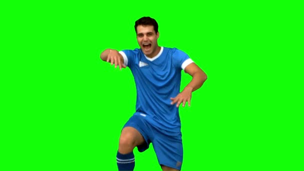 Football player celebrating a goal on green screen — Stock Video