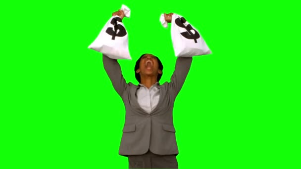 Businesswoman holding money bags on green screen — Stock Video