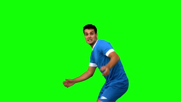 Handsome football player warming up on green screen — Stock Video