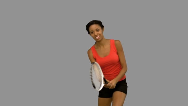 Pretty woman playing tennis on grey screen — Stock Video