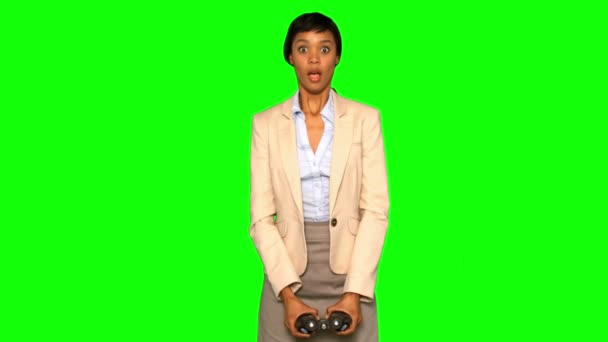 Astonished businesswoman using binoculars — Stock Video