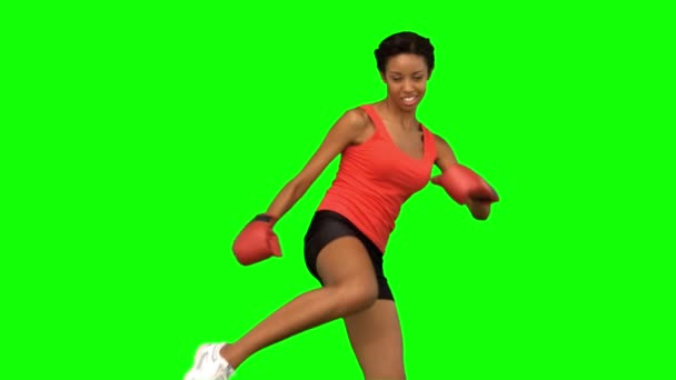 Woman performing air kick on green screen — Stock Video