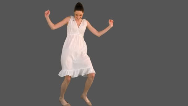 Elegant young woman in white dress dancing — Stock Video