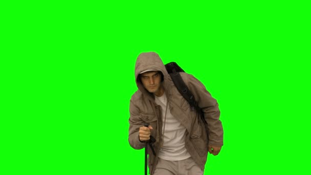 Handsome man with a coat trekking on green screen — Stock Video