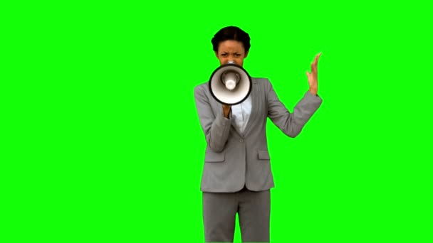 Businesswoman yelling into a megaphone on green screen — Stock Video