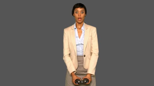 Astonished businesswoman holding binoculars — Stock Video