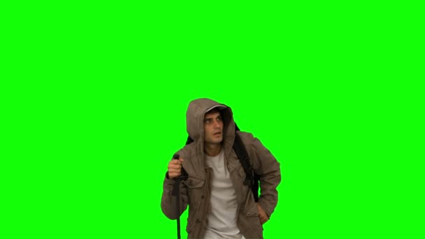 Man with a coat trekking on green screen — Stock Video