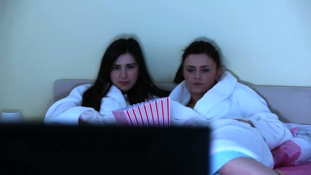 Young women watching horror movie together — Stock Video