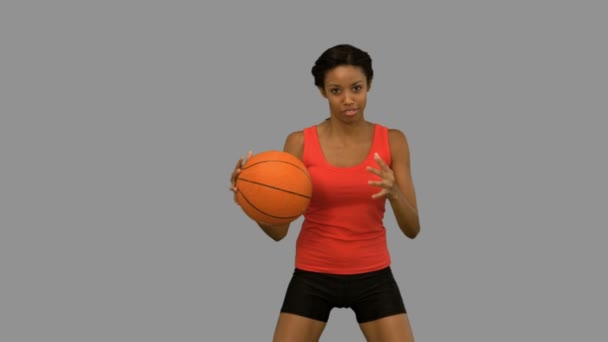 Pretty woman playing basketball on grey screen — Stock Video