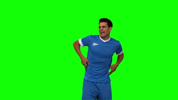 Football player calling doctors on green screen — Stock Video