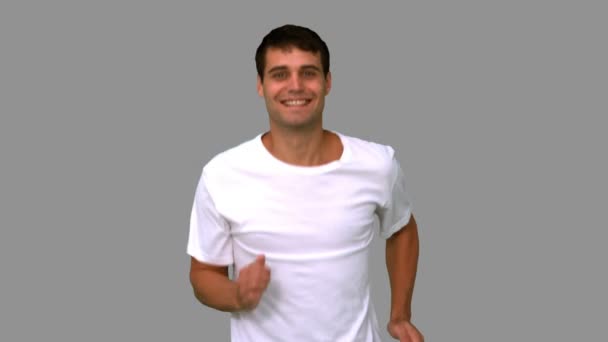 Man jogging on grey screen — Stock Video