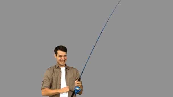 Man fishing on grey screen — Stock Video