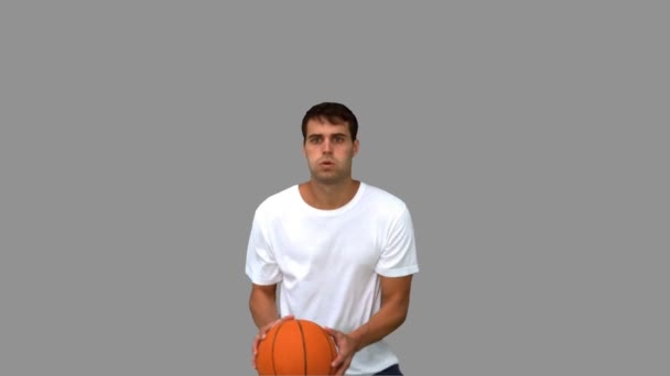 Man catching and throwing a basketball on grey screen — Stock Video