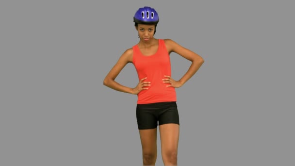 Cyclist woman standing on grey screen — Stock Video