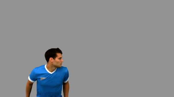 Красавчик, играющий в футбол на сером экране — стоковое видео