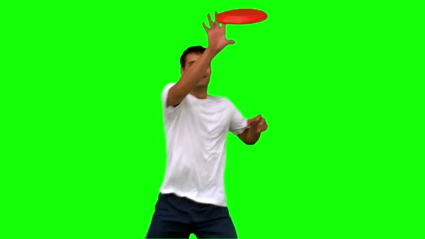 Man catching a frisbee on green screen — Stock Video