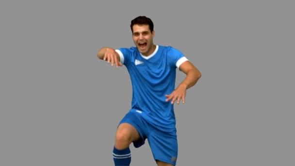 Football player celebrating a goal on grey screen — Stock Video