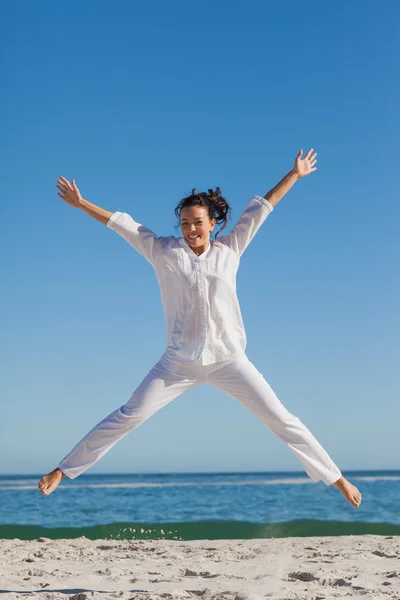 Smiling woman jumping up — Stock Photo, Image