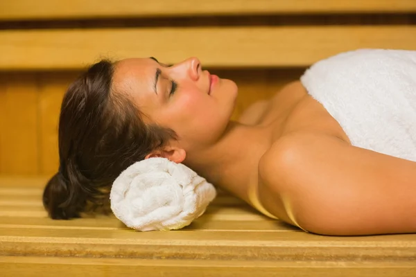 Peaceful brunette relaxing in a sauna — Stock Photo, Image